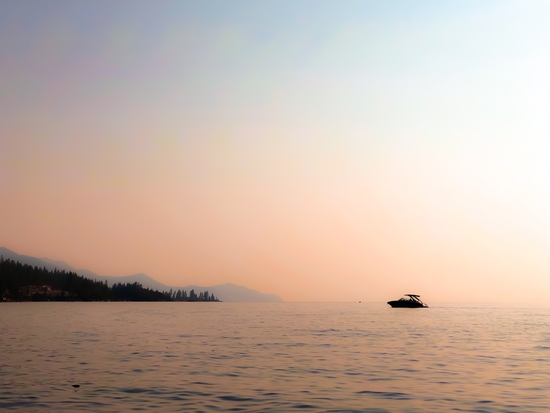 boat on the lake with sunset light at Lake Tahoe USA by Timmy333